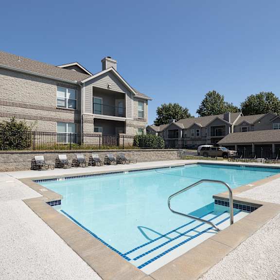 The pool area, features clear blue water and plenty of space to relax.